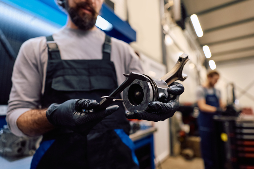 mechanic-examining-car-piston-in-automotive-repair-2026-01-17-23-28-39-utc